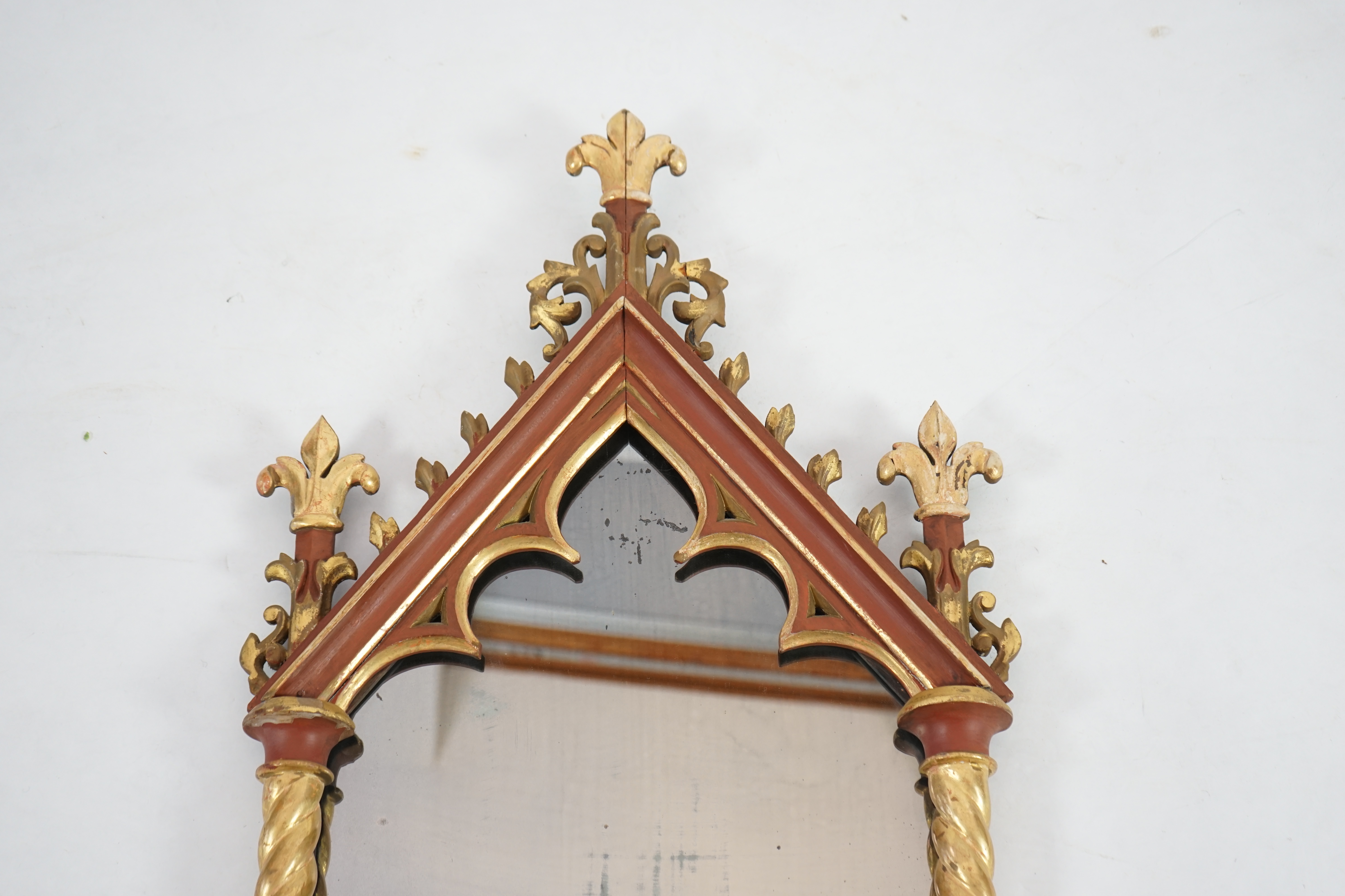 A Victorian Gothic revival painted and giltwood wall mirror